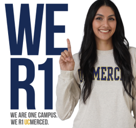 A woman in a gray shirt with UCMERCED on it, pointing upwards next to large text WE R1.